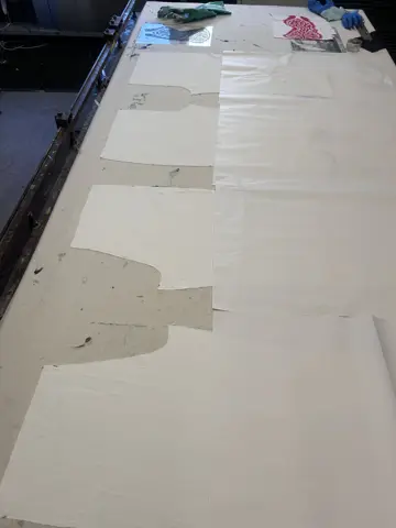 Red printed fabric pieces laid out on a table