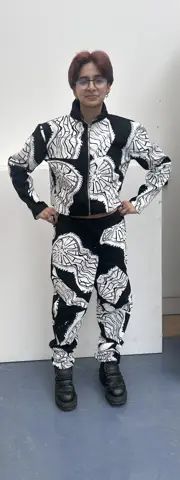 Model wearing black and white printed suit