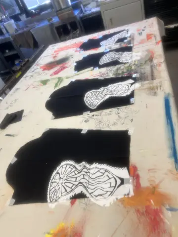 White stencil print on black fabric
