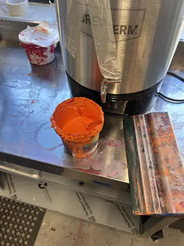 Orange prints on black fabric panels