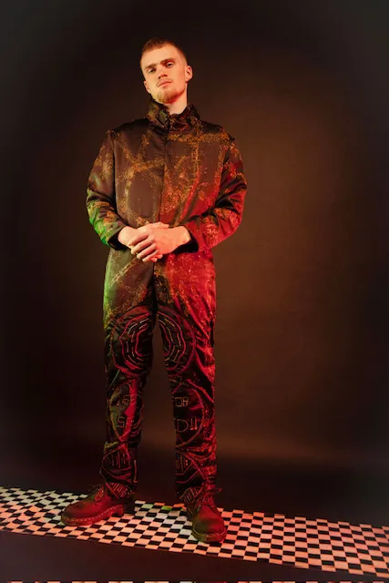 WorkWear 24/25 studio photograph — model in embroidered racing jacket under red light