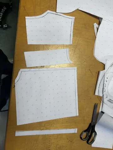 Pattern pieces laid on gold-printed fabric